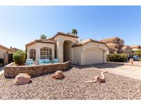Charming single-story home featuring desert landscaping, a two-car garage, and a cozy seating area at the front of the property at 4779 W Tulsa St, Chandler, AZ 85226