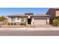 Charming single-story home with a two-car garage and low-maintenance desert landscaping at 5226 W Thresher Way, Laveen, AZ 85339