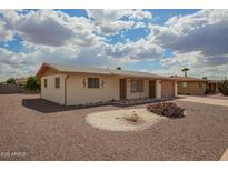 Charming single-story home with desert landscaping under a beautiful blue sky at 5323 E Dodge St, Mesa, AZ 85205