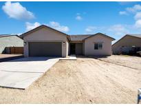Charming single-story home showcasing a gray garage door, stucco exterior, and a well-maintained front yard at 5719 E Santa Clara Dr, San Tan Valley, AZ 85140