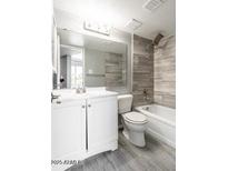 Modern bathroom features a bathtub, vanity, and stylish gray tiling at 6240 N 16Th St # 40, Phoenix, AZ 85016