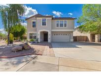 Inviting two-story home featuring a neutral color palette, well-maintained landscaping, and a spacious two car garage at 10865 E Florian Ave, Mesa, AZ 85208