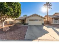 Charming single-story home with a well-manicured lawn, desert landscaping and a private two-car garage at 1750 N Abner --, Mesa, AZ 85205