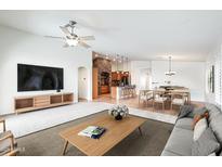 Spacious living room flows into the kitchen and dining area, creating a seamless entertaining space at 3005 W Donatello Dr, Phoenix, AZ 85086