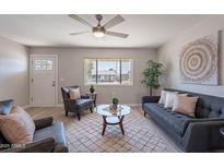 Inviting living room with cozy seating, natural light, ceiling fan, and stylish decor at 7526 E Mckinley St, Scottsdale, AZ 85257