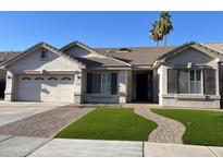 Charming single-story home with a well-maintained front yard and a two-car garage at 1444 W Spruce Dr, Chandler, AZ 85286