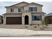 Charming two-story home featuring a two-car garage, desert landscaping, and decorative shutters at 21608 N Belt Dr, Maricopa, AZ 85138