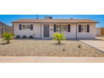 Charming single-story home featuring a desert landscape, covered entryway, and dark shuttered windows at 3249 E Nisbet Rd, Phoenix, AZ 85032