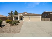 Charming single-story home with a two-car garage and low-maintenance desert landscaping in front yard at 3336 E Thornton Ave, Gilbert, AZ 85297