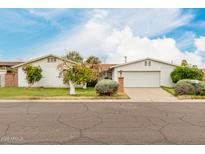 Charming single-story home featuring a two-car garage, mature landscaping, and a well-maintained lawn at 7844 N 17Th Ave, Phoenix, AZ 85021