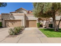 Charming townhome with a two-car garage and desert landscaping at 9705 E Mountain View Rd # 1064, Scottsdale, AZ 85258