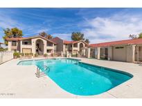 Sparkling community pool with lounge area surrounded by well-maintained landscaping at 10610 S 48Th St # 1068, Phoenix, AZ 85044