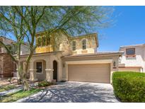 Two-story home features a stucco facade, two-car garage and covered porch with an arched entryway at 12030 W Polk St, Avondale, AZ 85323