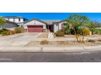 Charming single-story home with a red garage door, neutral stucco, and desert landscaping under a clear blue sky at 14188 W Artemisa Ave, Surprise, AZ 85387