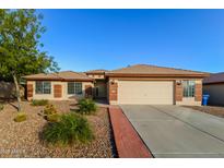 Charming single-story home with desert landscaping and a two-car garage, great curb appeal at 15298 W Watson Ln, Surprise, AZ 85379