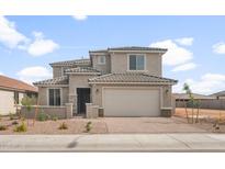 Inviting two-story home featuring a neutral color palette, tile roofing, and a spacious two-car garage at 17633 W Palo Verde Dr, Litchfield Park, AZ 85340