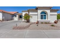 Charming home featuring desert landscaping, a concrete driveway, and an inviting exterior with unique architectural details at 17988 W Deneen Way, Surprise, AZ 85374