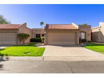 Charming single-story home featuring a tile roof, desert landscaping, and attached garage at 19116 N 98Th Dr, Peoria, AZ 85382