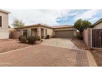 Charming single-story home featuring a two-car garage, brick driveway, and desert landscaping at 2624 E La Costa Dr, Chandler, AZ 85249