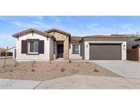 Beautiful single-story home with a stone facade and a two-car garage at 37650 W Nina St, Maricopa, AZ 85138