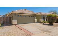 Charming single-story home with a beige exterior, tile roof, and well-maintained landscaping at 3805 S 73Rd Dr, Phoenix, AZ 85043