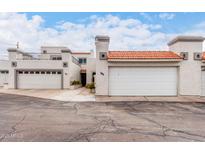 Charming townhome featuring a two-car garage and a red tile roof, perfect for comfortable living at 4757 W Caron St, Glendale, AZ 85302