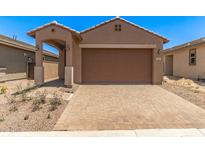 Charming single-story home with a well-maintained front yard and a two-car garage at 5641 N 205Th Ln, Buckeye, AZ 85396