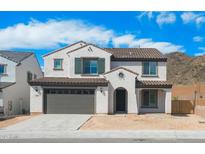 Charming two-story home with a tile roof, desert landscaping, and a two car garage at 6980 W Hedge Hog Pl, Peoria, AZ 85383