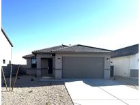 Beautiful single-story home featuring a neutral color scheme, tile roof, and a well-manicured front yard at 7267 E Hackamore Ln, San Tan Valley, AZ 85143