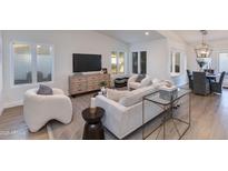 Bright living room features neutral decor, with modern furniture and large windows, for ample natural light at 8031 E Redwing Rd, Scottsdale, AZ 85250