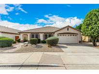 Charming single-story home with a well-manicured front yard, desert landscaping, and attached two-car garage at 9715 E Osage Ave, Mesa, AZ 85212