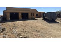 Exterior view of home under construction with a large three car garage and dumpster at 13515 N Granite Way, Fountain Hills, AZ 85268