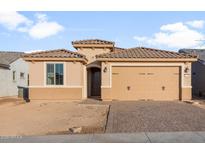 Inviting single-story home with tan stucco, a tile roof, two-car garage, and a paver driveway at 21281 N 270Th Dr, Buckeye, AZ 85396