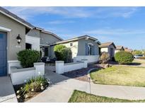 Charming single-story home featuring desert landscaping, covered patio and a beautiful walkway at 2483 E Narrowleaf Dr, Gilbert, AZ 85298