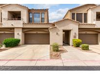 Inviting townhome showcasing a private garage, manicured landscaping, and an appealing neutral color palette at 3131 E Legacy Dr # 2018, Phoenix, AZ 85042