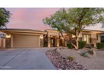 Charming home with stone accents, desert landscaping, and a three-car garage at 32215 N 16Th Ave, Phoenix, AZ 85085