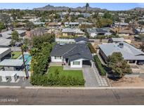 Charming home with well-manicured lawn, pool, and beautiful desert landscaping in a desirable neighborhood at 3516 E Earll Dr, Phoenix, AZ 85018