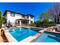 Sparkling pool and spa surrounded by travertine tile, perfect for relaxation and entertaining at 4167 E Sierra Madre Ave, Gilbert, AZ 85296