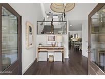 Charming foyer with views to the living and dining area features dark wood floors and modern finishes at 4446 E Camelback Rd # 104, Phoenix, AZ 85018