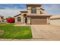 Charming two-story home with a well-maintained lawn, desert landscaping, and a spacious two-car garage at 4604 E Summerhaven Dr, Phoenix, AZ 85044
