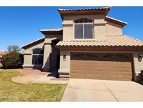 Charming two-story home boasts well-maintained landscaping and a spacious two-car garage at 4604 E Summerhaven Dr, Phoenix, AZ 85044