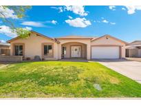 Charming single-story home with a well-manicured lawn and a welcoming front entrance with an arched entryway at 5115 W Kings Ave, Glendale, AZ 85306