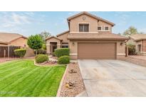 Charming two-story home with a well-maintained lawn and a two car garage at 6112 N Almanza Ln, Litchfield Park, AZ 85340