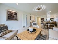 Inviting living room with modern decor, light wood floors and a stylish light fixture at 7430 E Chaparral Rd # A243, Scottsdale, AZ 85250