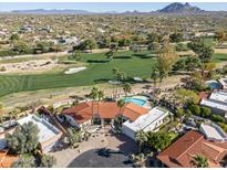 Stunning aerial view of a home with a pool overlooking the manicured golf course at 8262 E Vista De Valle --, Scottsdale, AZ 85255