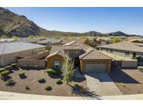Charming single-Gathering home featuring a tile roof and a two-car garage in a well-maintained community at 10251 W Gambit Trl, Peoria, AZ 85383