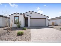 Beautiful single-story home with desert landscaping and a brick driveway at 11341 E Unger Ave, Mesa, AZ 85212