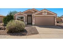 Charming single-story home with well-maintained landscaping and a two-car garage at 1137 W 21St Ave, Apache Junction, AZ 85120