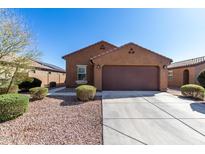 Charming single-story home featuring a two-car garage, desert landscaping, and a neutral-toned exterior at 1739 E Elegante Dr, Casa Grande, AZ 85122