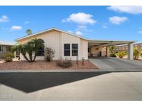Charming single-story home features desert landscaping, covered parking, and a well-maintained facade at 2550 S Ellsworth Rd # 765, Mesa, AZ 85209